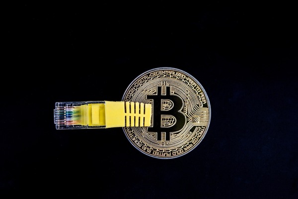 Ethereum coin next to a hardware wallet device representing native ETH and wrapped token storage