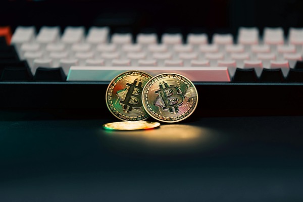 TRON coin displayed beside an Ethereum coin on a desk